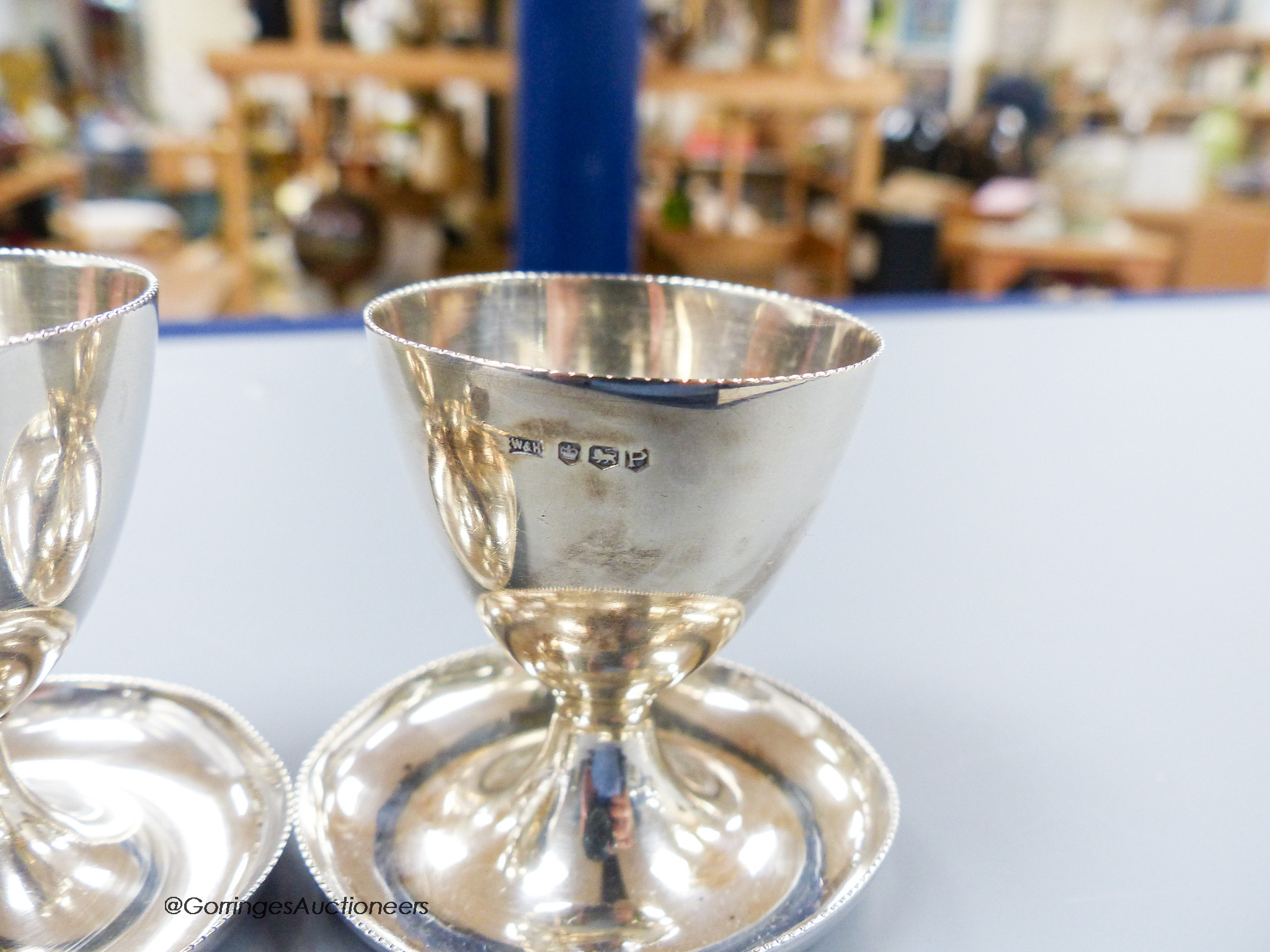 A pair of 1950's silver egg cups, Walker & Hall, Sheffield, 1957/8, 55mm and one other silver egg cup, 131 grams.